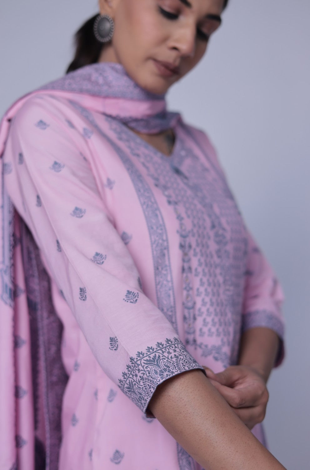 Model gracefully showcasing the long, elegant trail of the baby pink patterned jacquard dupatta, complementing the cotton suit set.
