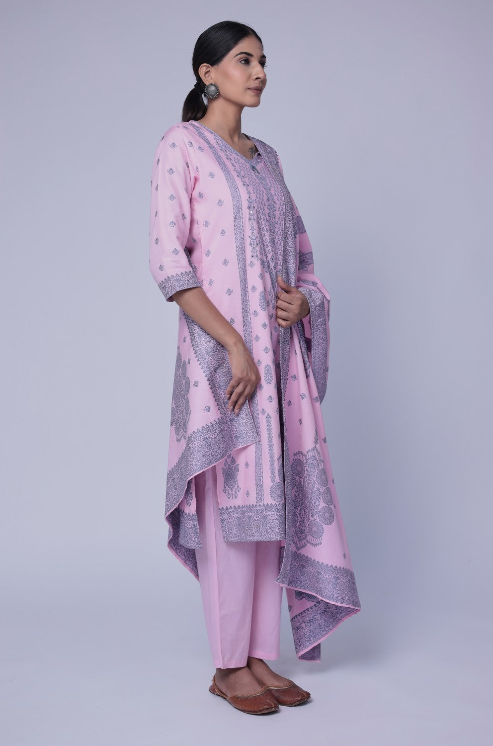 Model in a confident stance, highlighting the full length and overall elegant design of the baby pink cotton jacquard dupatta set with merging embroidery.