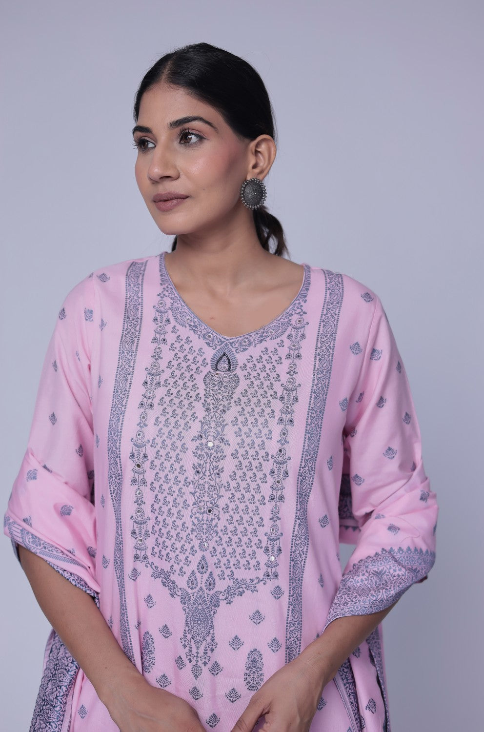 Side profile of model showcasing the comfortable fit and elegant drape of the baby pink cotton jacquard dupatta set with merging embroidery.