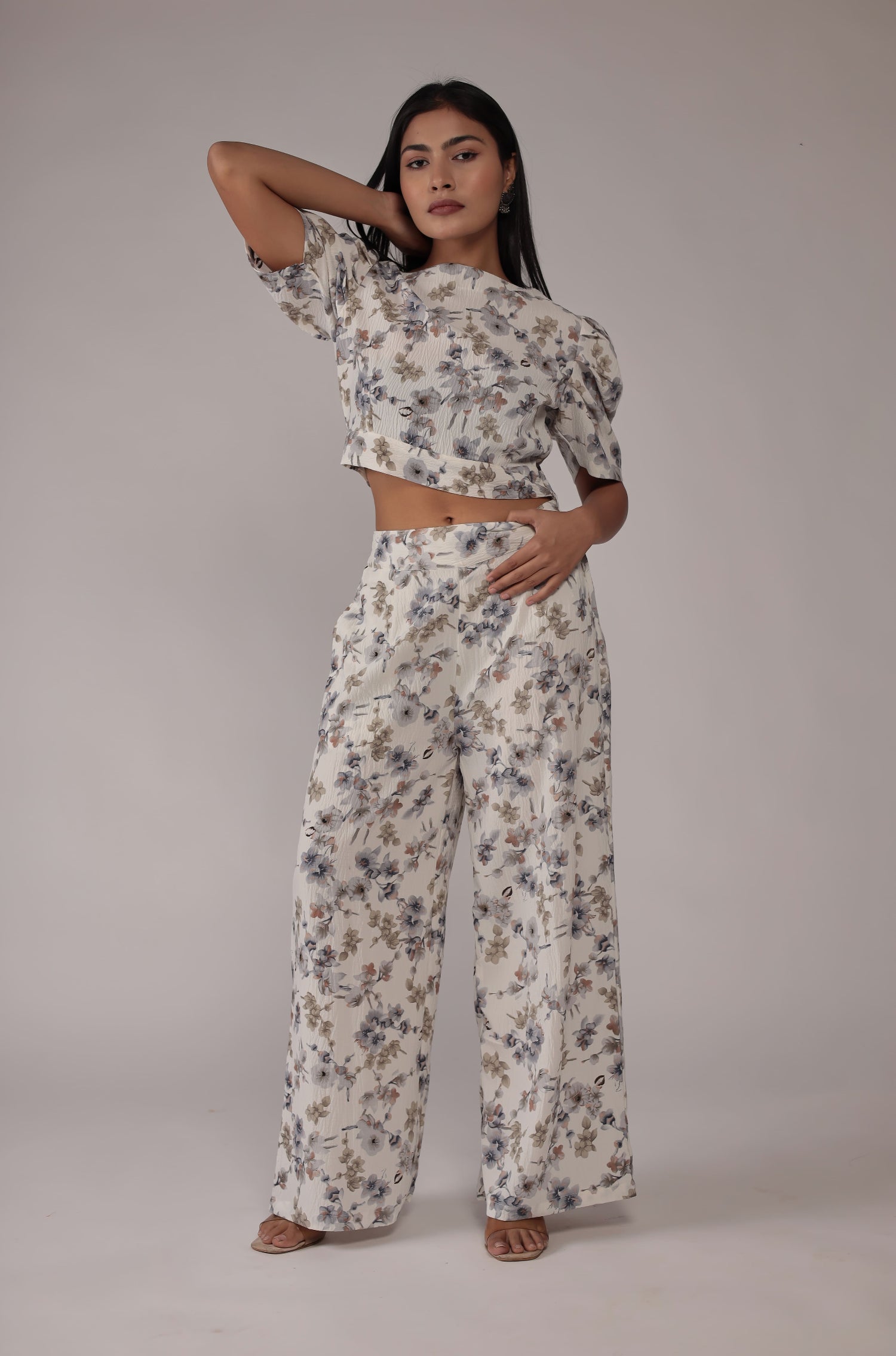 Side profile of model showcasing the relaxed fit and elegant floral print of the cream co-ord set.