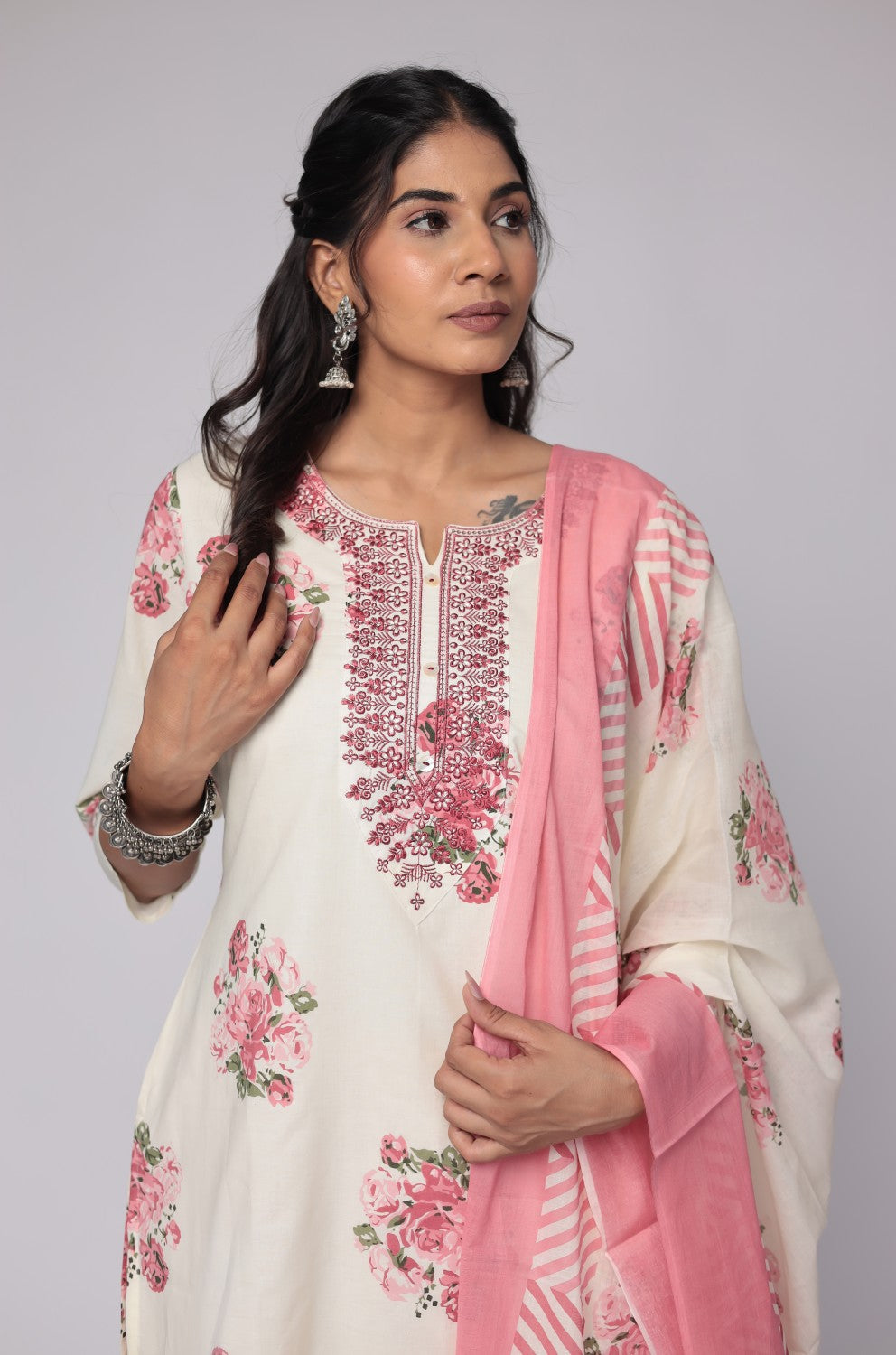 Side profile of model showcasing the comfortable fit and elegant drape of the cream and red Jaipuri print dupatta set with mulmul lining.