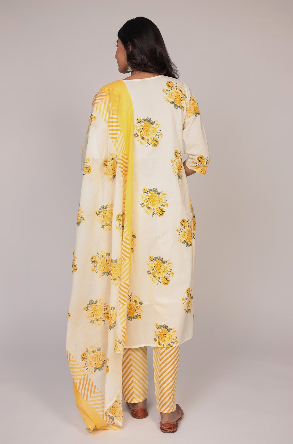 Back view of the cream and yellow Jaipuri print kurta set, showing the consistent pattern on the kurti and striped pants, with mulmul lining.