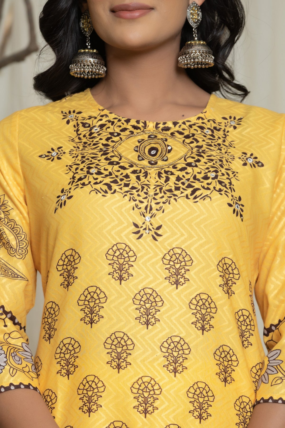 Close-up of the delicate handwork detailing on the round neckline of the elegant yellow Lapet digital print kurta, highlighting intricate patterns.