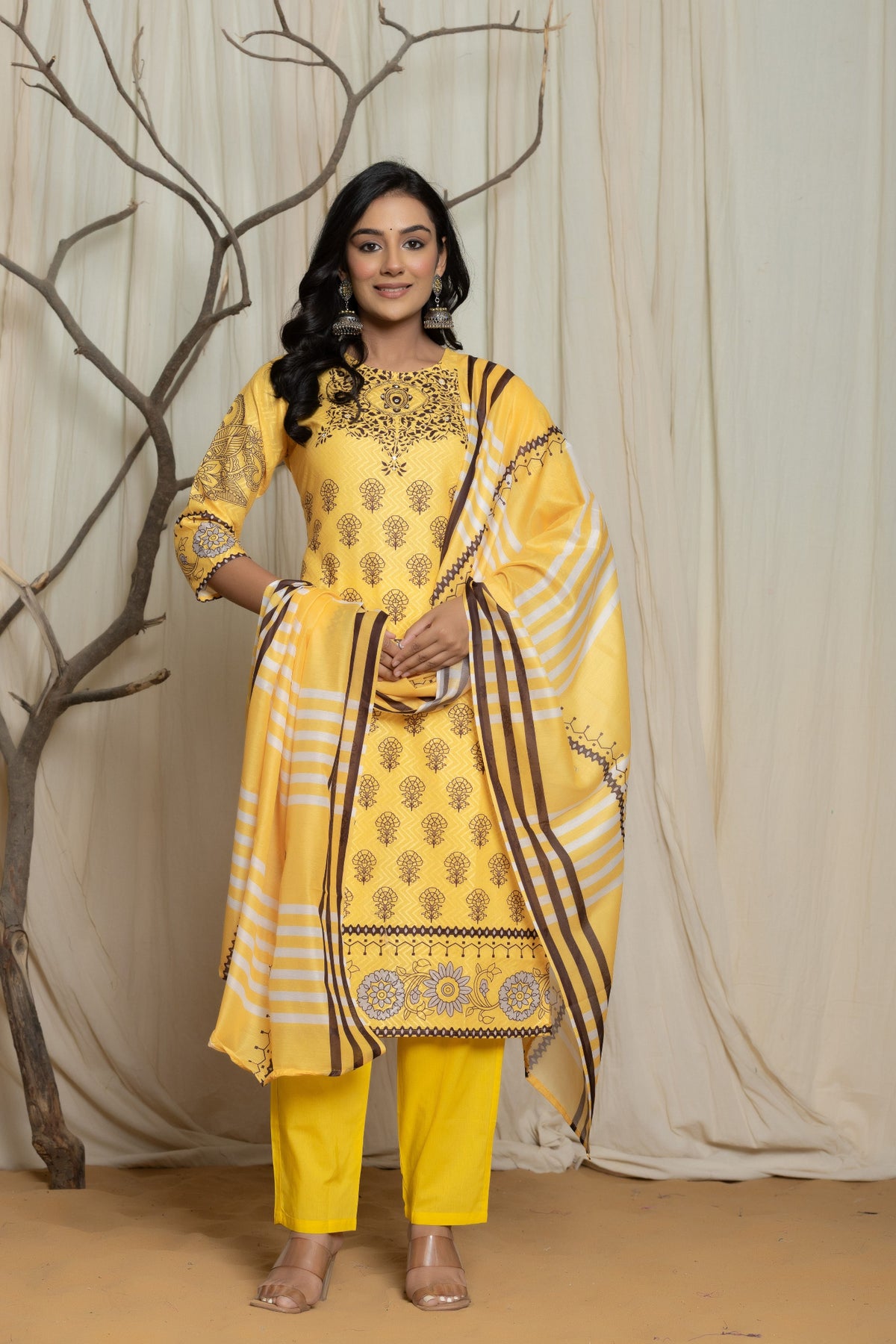 Model wearing an elegant yellow Lapet fine digital print dupatta set from The Navra, featuring intricate handwork detailing on the kurta and a striped floral printed dupatta. Ideal for comfortable daily or semi-formal ethnic wear.