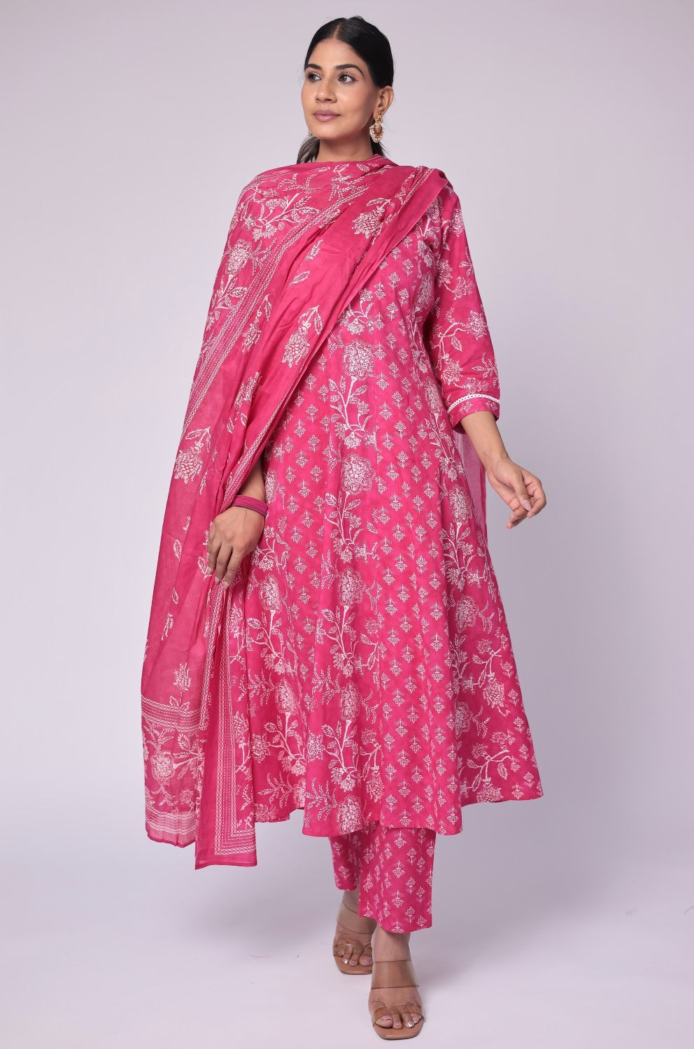 Model in a confident stance, highlighting the full length and vibrant Jaipuri print design of the fuchsia pink cotton Anarkali set.
