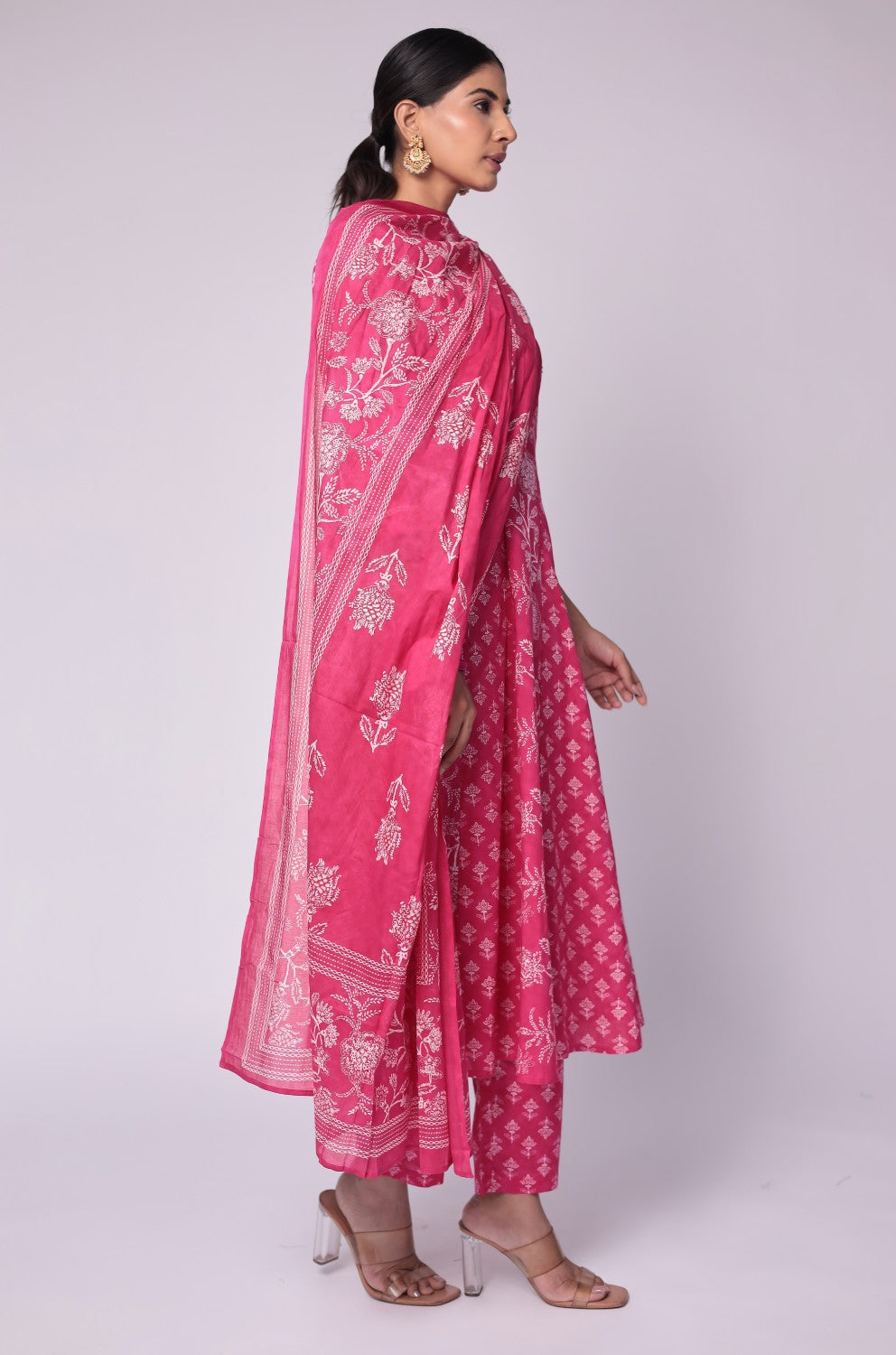 Side profile of model showcasing the voluminous flare and elegant drape of the fuchsia pink cotton Anarkali Jaipuri print dupatta set.
