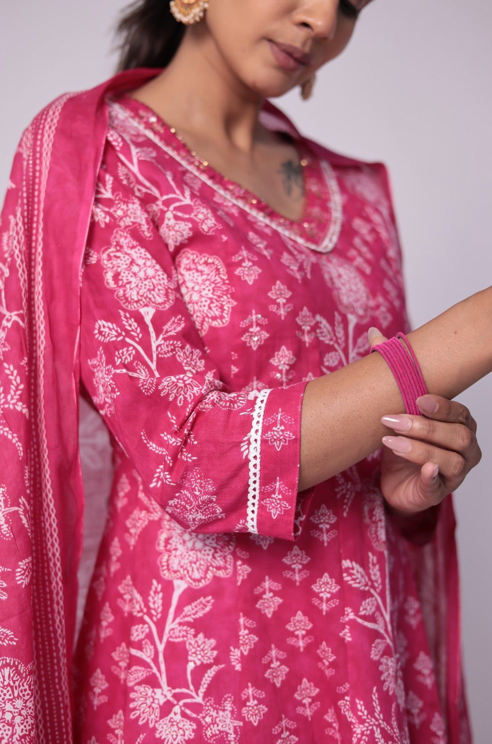 Detailed view of the sleeve and floral Jaipuri print on the fuchsia pink cotton Anarkali kurta, showcasing the intricate patterns.