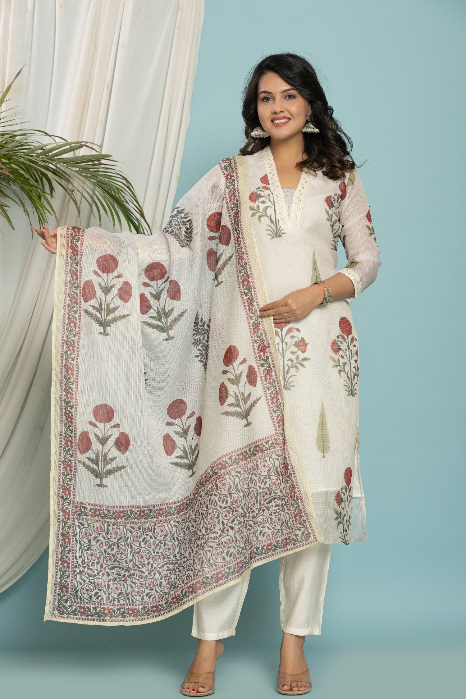 Model wearing white Kota Doria dupatta set from The Navra, featuring a floral print kurti and matching dupatta, with soft silk pants. Ideal for casual or daily wear.