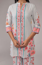 Close-up of the beautiful pink and blue floral digital print and design on the collared neckline and front of the light grey kurta, from the co-ord set.