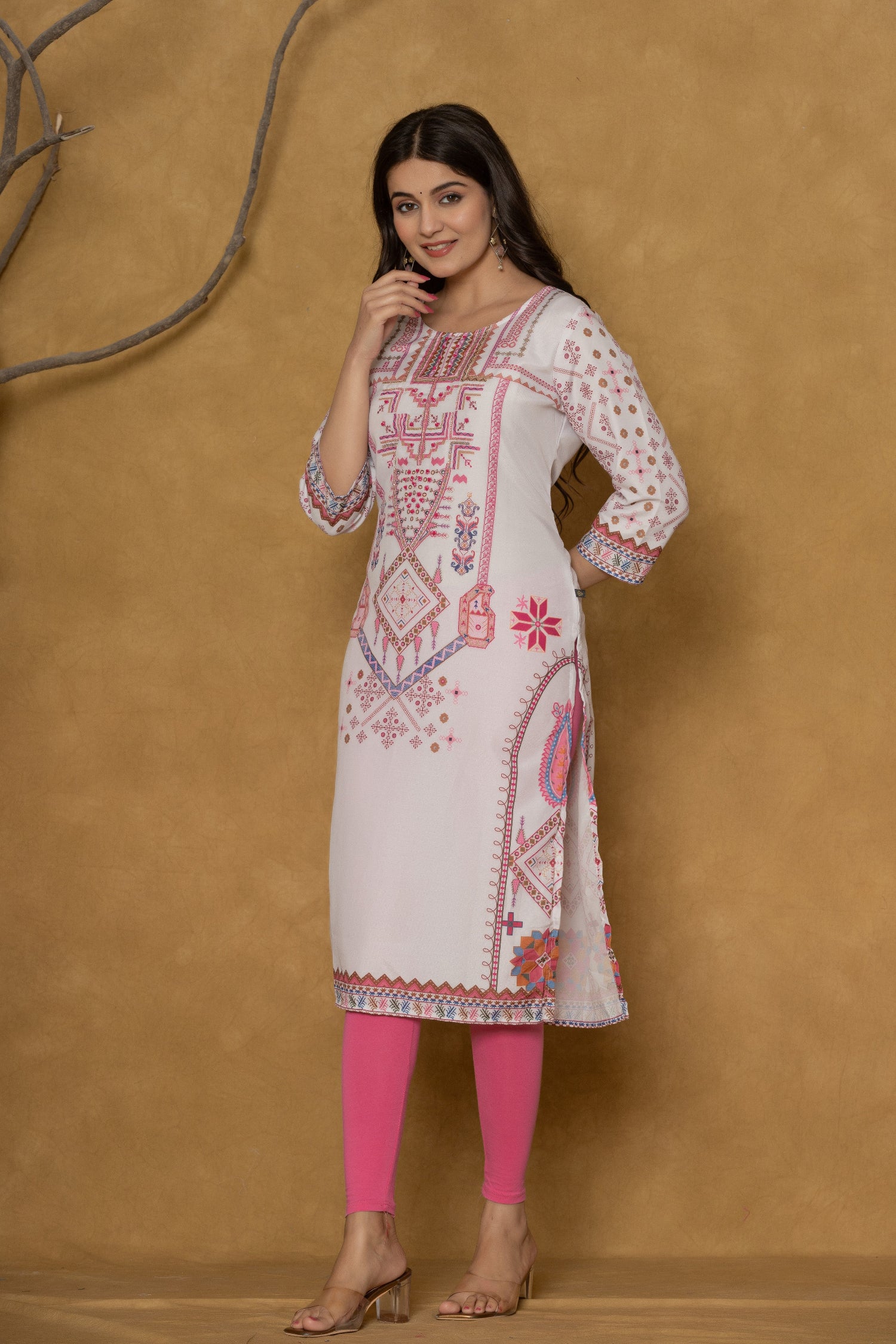 Model wearing a light purple pannel kurta from The Navra, featuring intricate handwork on the round neck and delicate patterns in pink and purple, paired with bright pink leggings. Ideal for casual and daily ethnic wear.
