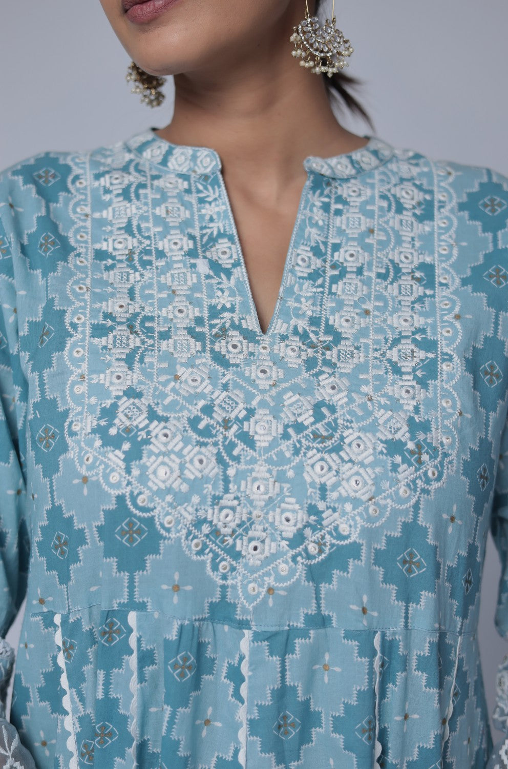 Side profile of model showcasing the voluminous flare and elegant drape of the ocean blue cotton Anarkali dupatta set with white thread work.