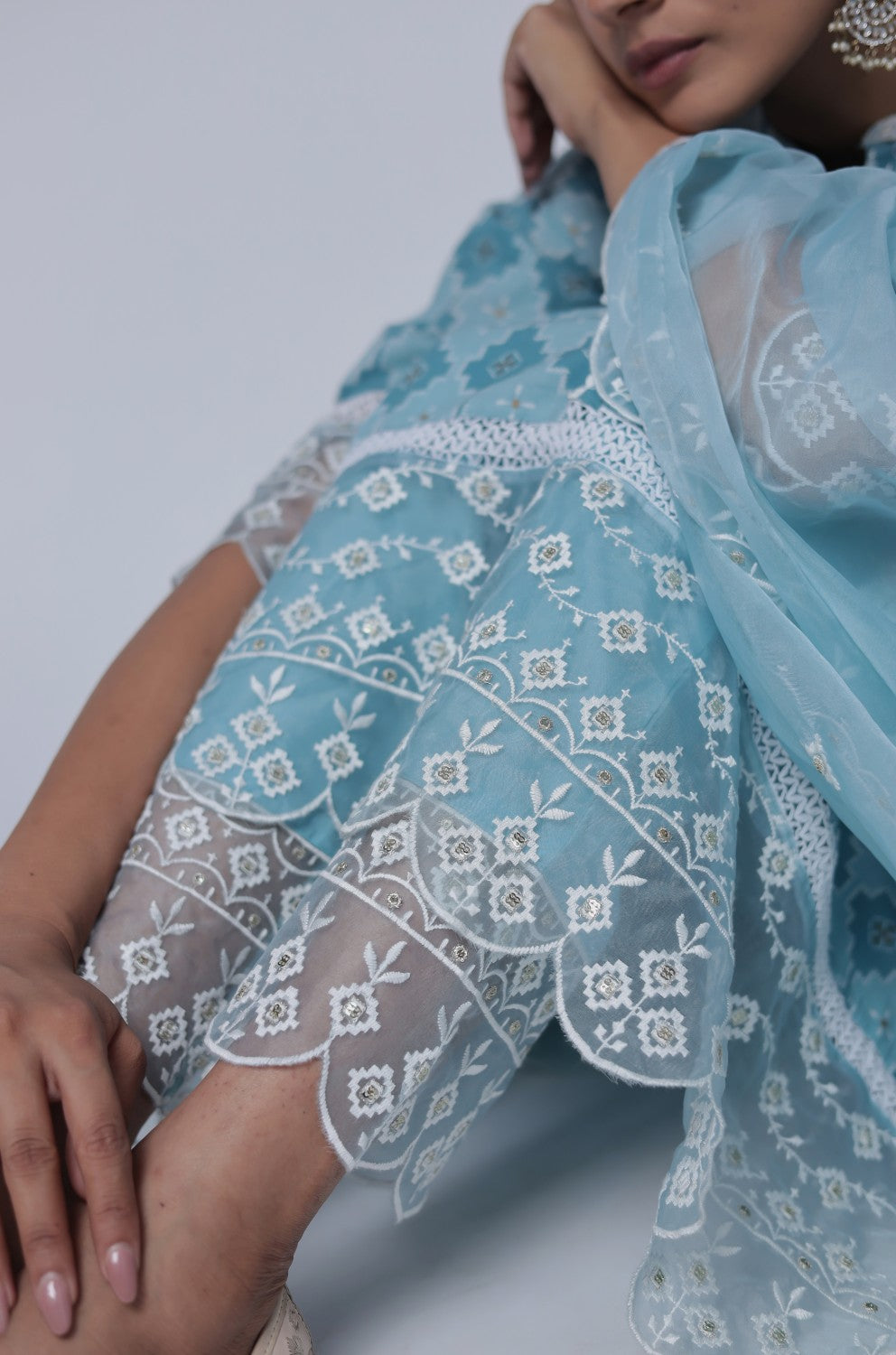 Detailed view of the sleeve and intricate white thread work on the cuffs and patterns of the ocean blue cotton Anarkali kurta.