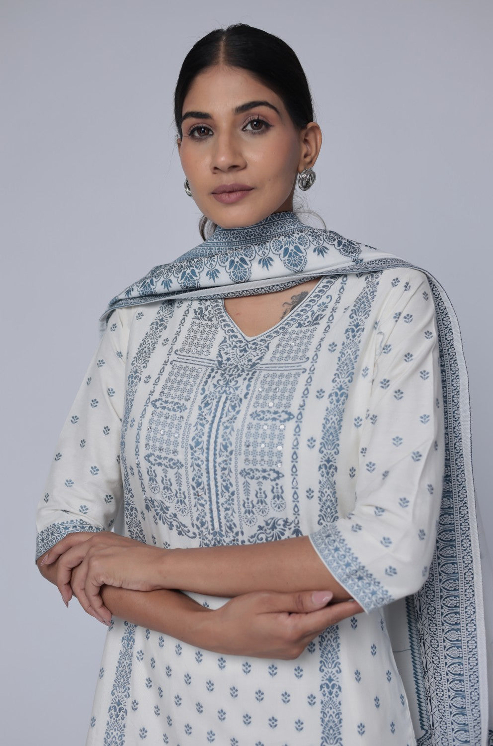 Side profile of model showcasing the comfortable fit and elegant drape of the off-white cotton jacquard dupatta set with blue detailing.