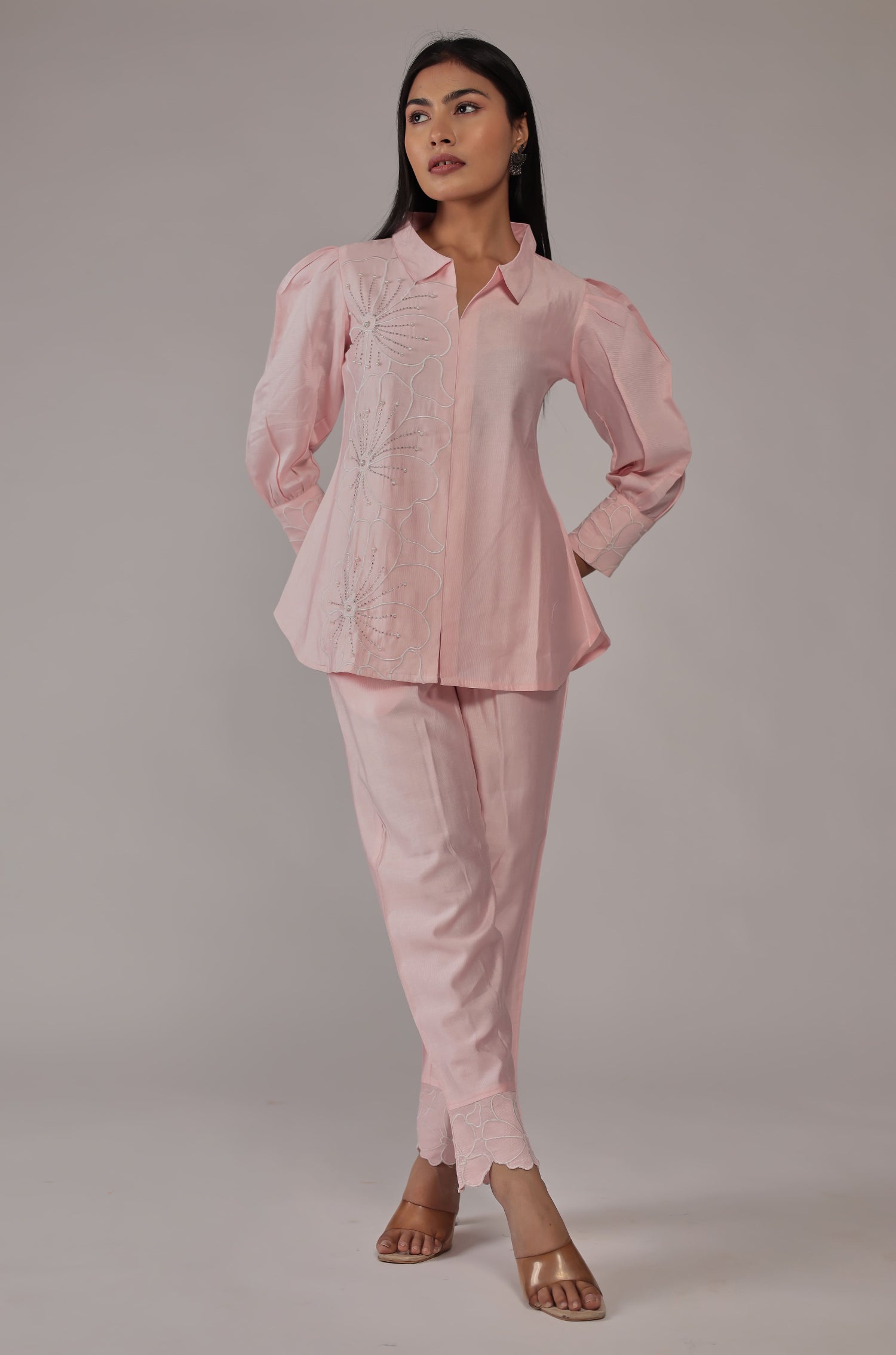 Side profile of model showcasing the modern cut and comfortable fit of the pink co-ord set with creative work details.
