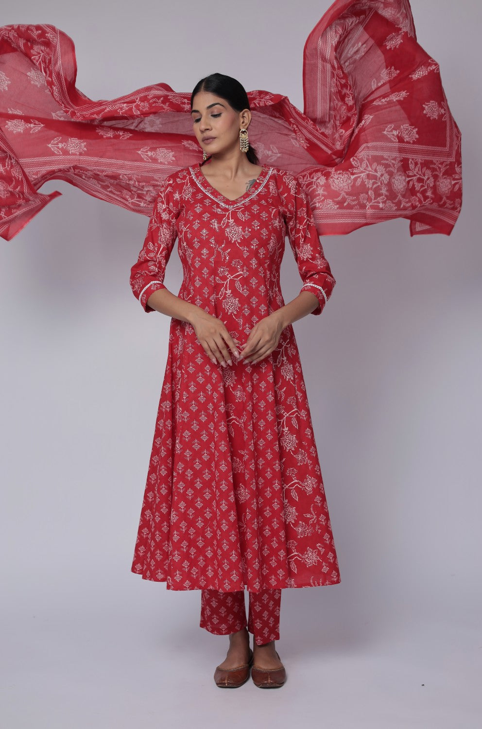 Model gracefully posing in the red cotton Anarkali Jaipuri print dupatta set, showcasing the expansive flow and elegant movement of the Anarkali and dupatta.