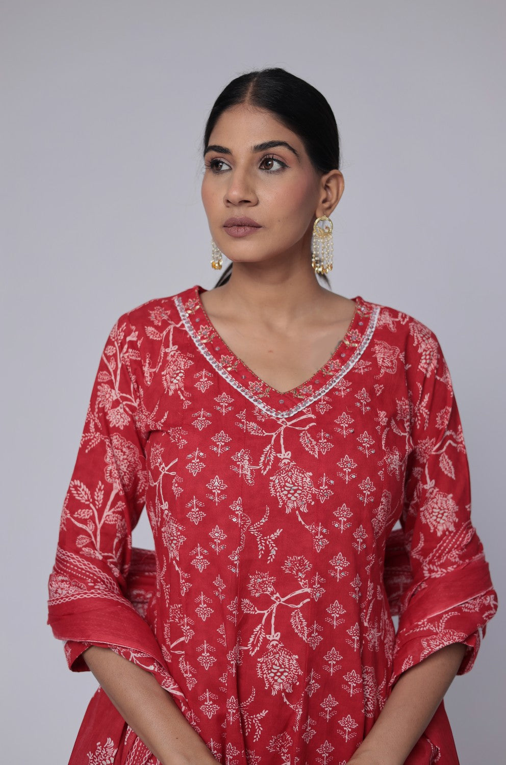 Side profile of model showcasing the voluminous flare and elegant drape of the red cotton Anarkali Jaipuri print dupatta set.