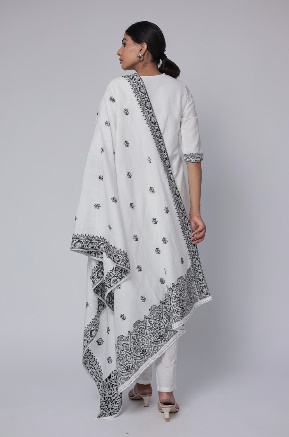 Back view of the off-white and black cotton jacquard dupatta set, showing the consistent pattern on the kurti and pants, with the matching patterned dupatta.