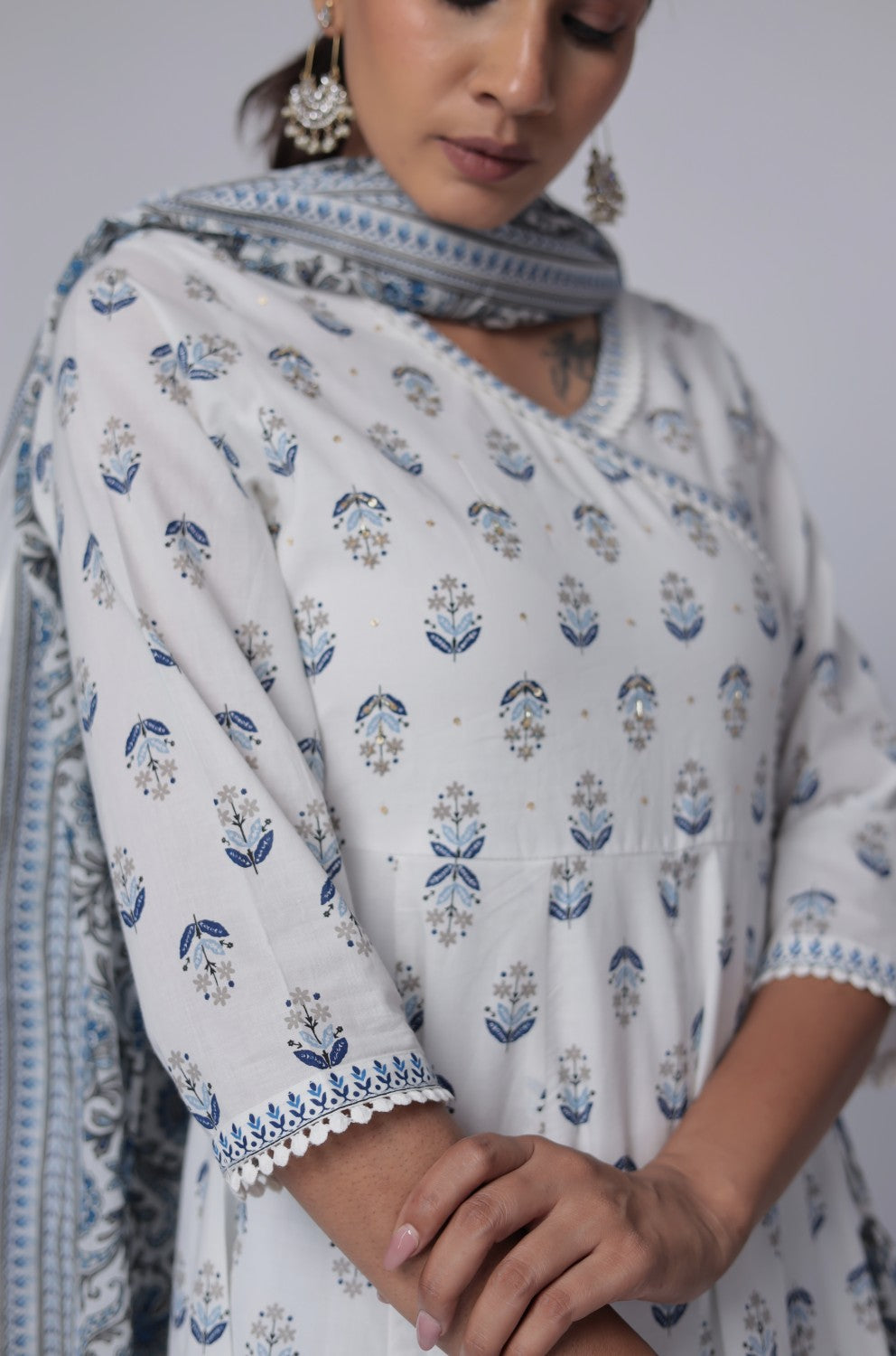 Side profile of model showcasing the voluminous flare and elegant drape of the white and blue cotton Anarkali Jaipuri print dupatta set.