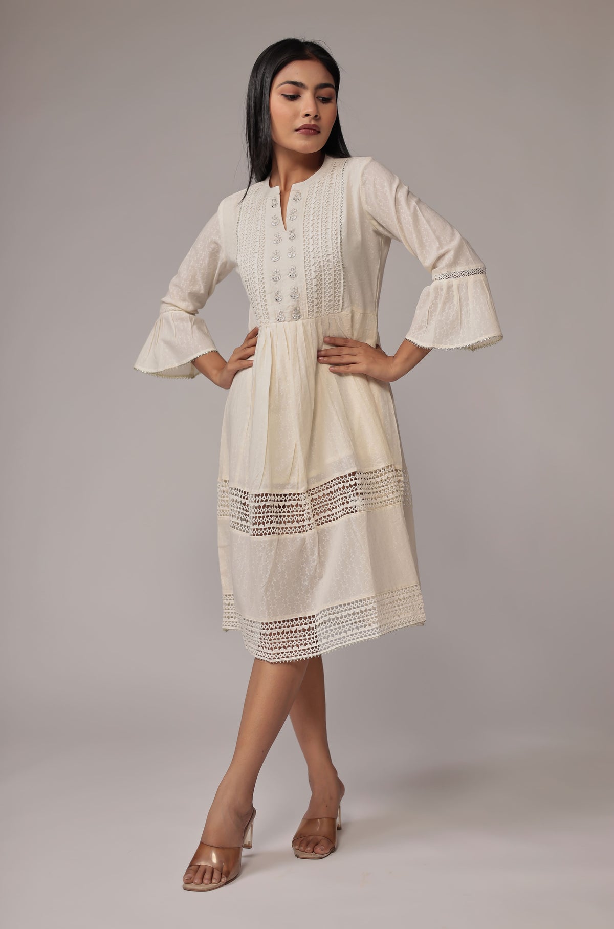 Back view of the white cotton dobby dress, showing the elegant flare and comfortable fit.