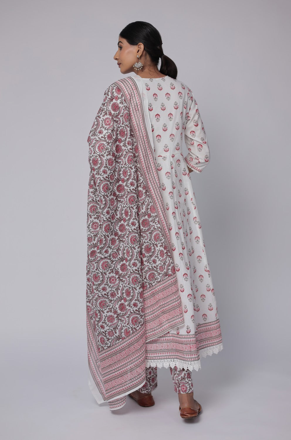Model gracefully posing with the white and red Jaipuri print dupatta flowing, showcasing its full design and elegant movement.