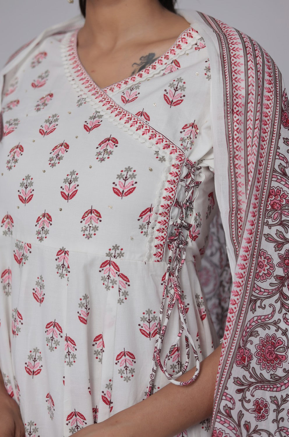 Back view of the white and red cotton Anarkali set, showing the consistent Jaipuri print on the kurta and pants, with crochet lace hem.