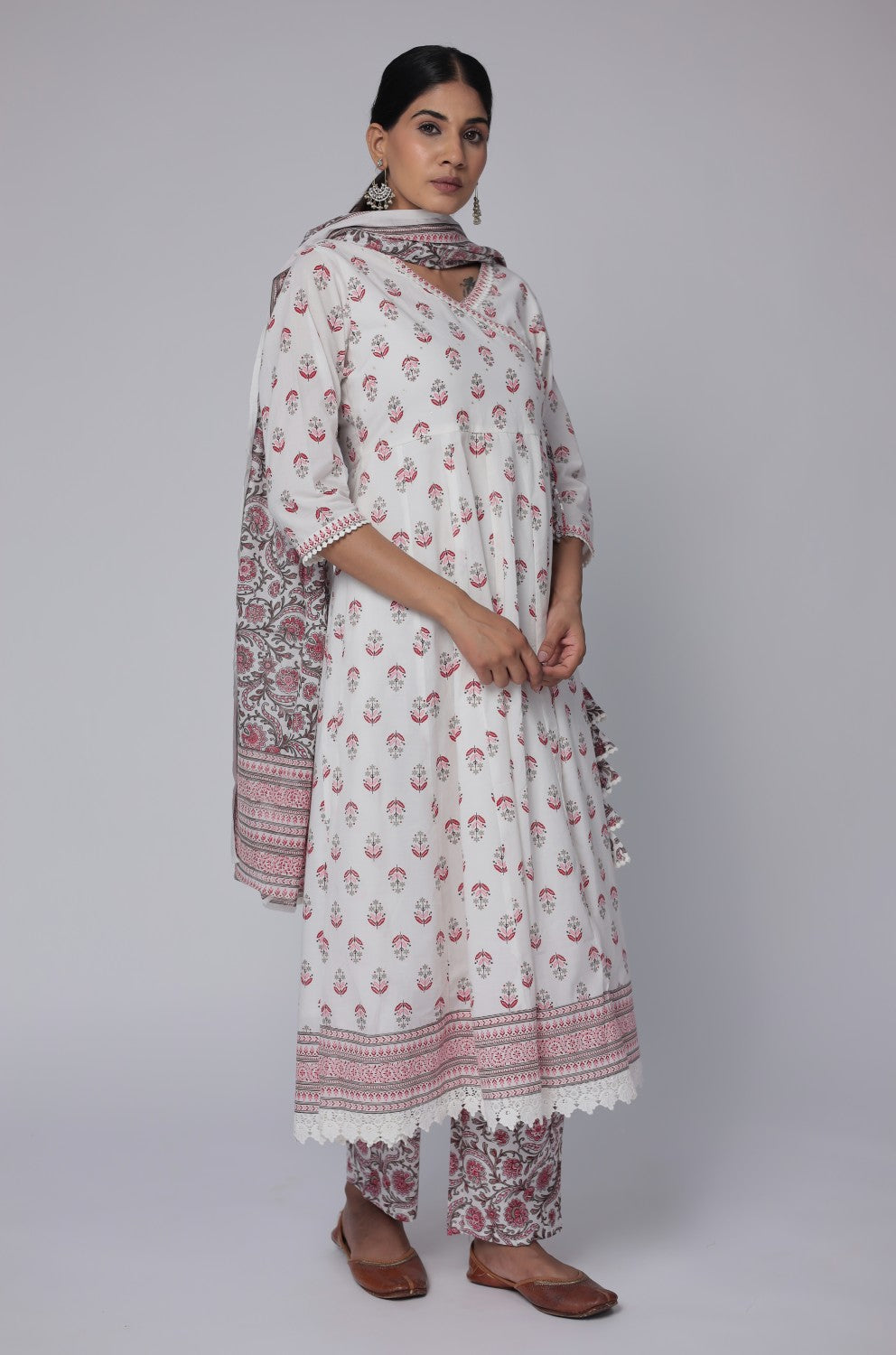Flat lay arrangement of the complete white and red cotton Anarkali set, featuring a Jaipuri print kurta with handwork and crochet lace hem, printed dupatta, and matching pants, showcasing full design details.