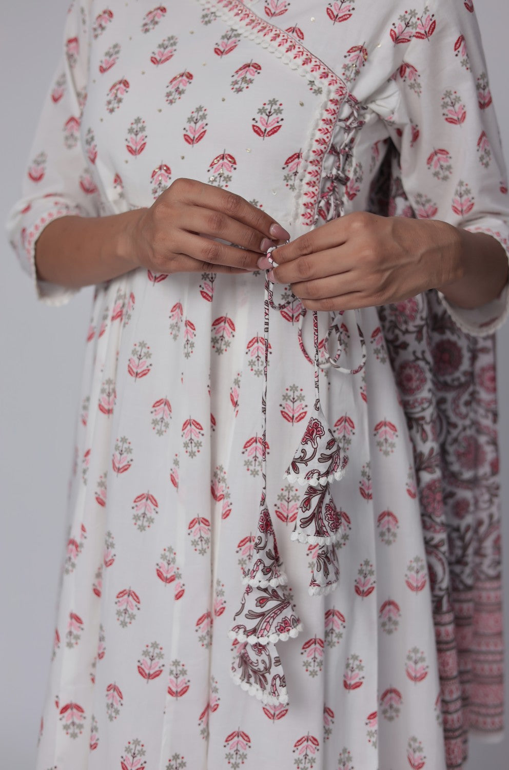 Detailed view of the sleeve and intricate Jaipuri print on the white and red cotton Anarkali kurta, showcasing the pattern.
