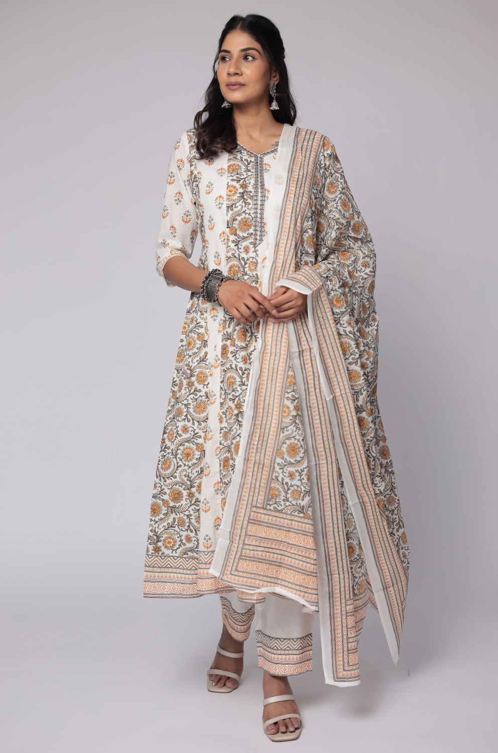 Flat lay arrangement of the complete white and yellow cotton Anarkali Jaipuri print dupatta set, including the handwork detailed kurta, printed dupatta, and matching pants, showcasing the full design.