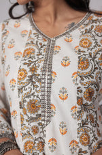 Close-up of the delicate handwork embroidery on the round neckline of the white and yellow cotton Anarkali kurta, highlighting intricate details.