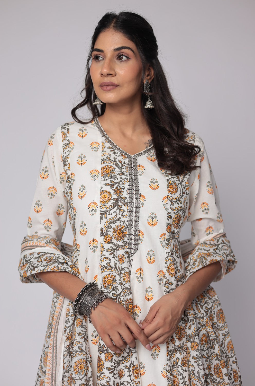 Side profile of model showcasing the voluminous flare and elegant drape of the white and yellow cotton Anarkali Jaipuri print dupatta set.