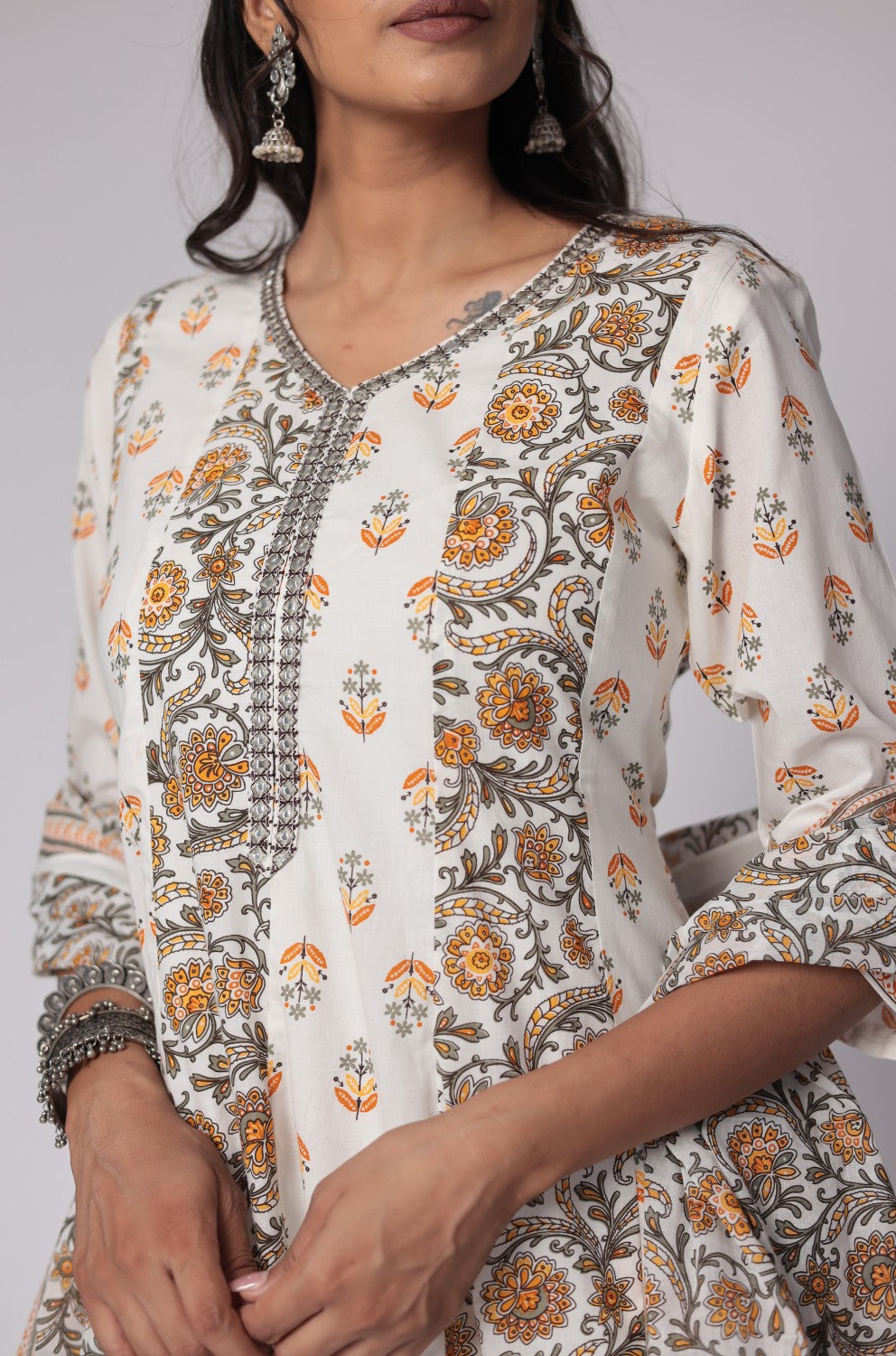 Detailed view of the sleeve and floral Jaipuri print on the white and yellow cotton Anarkali kurta, showcasing the intricate patterns.