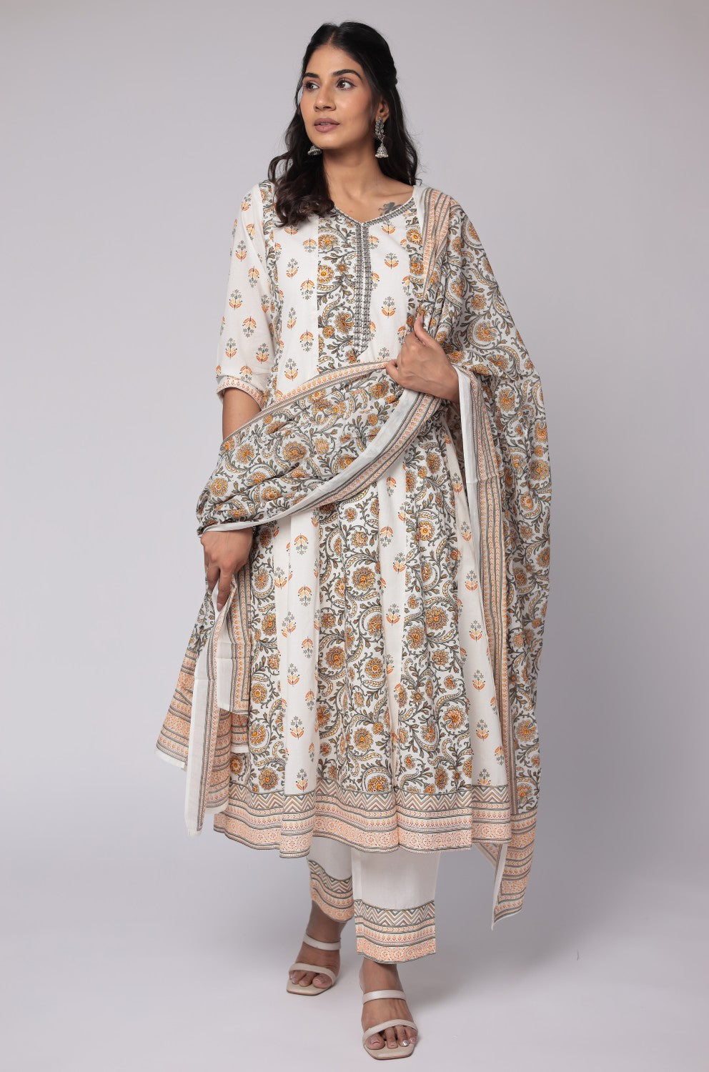 Model wearing a vibrant white and yellow cotton Anarkali dupatta set from The Navra, featuring intricate handwork on the neck, a flowing Jaipuri print kurta, and a matching printed dupatta. Ideal for comfortable daily or festive ethnic wear.