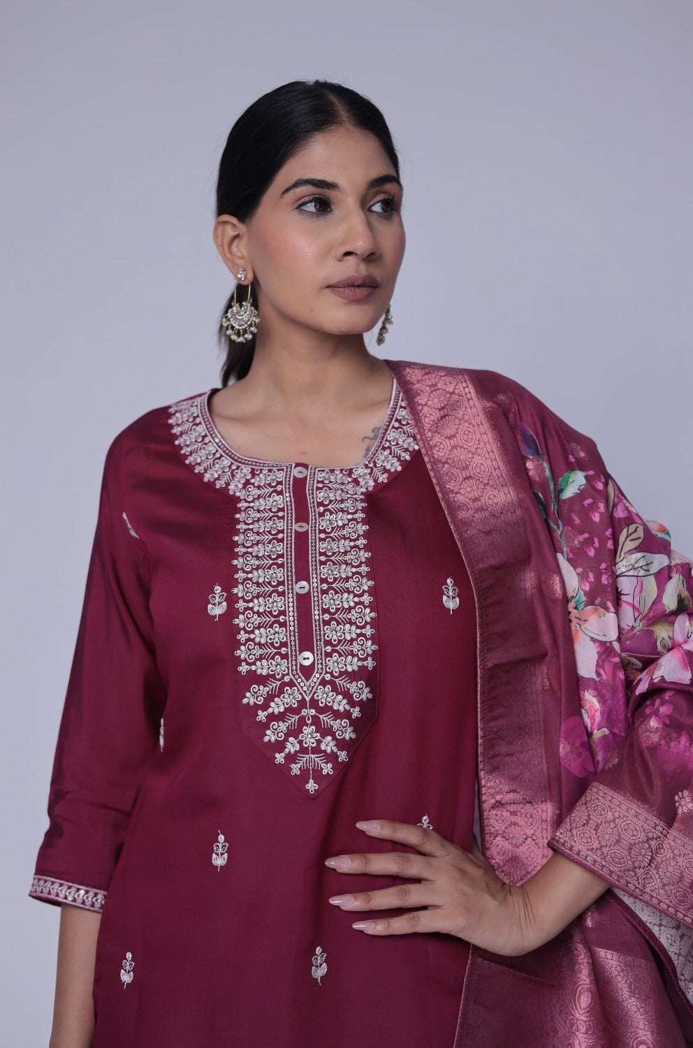 Side profile of model showcasing the elegant drape of the printed jacquard dupatta and the flattering fit of the wine soft silk suit set.