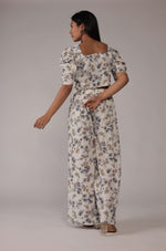Back view of the elegant cream printed co-ord set, showing the consistent floral pattern on the crop top and wide-leg pants.