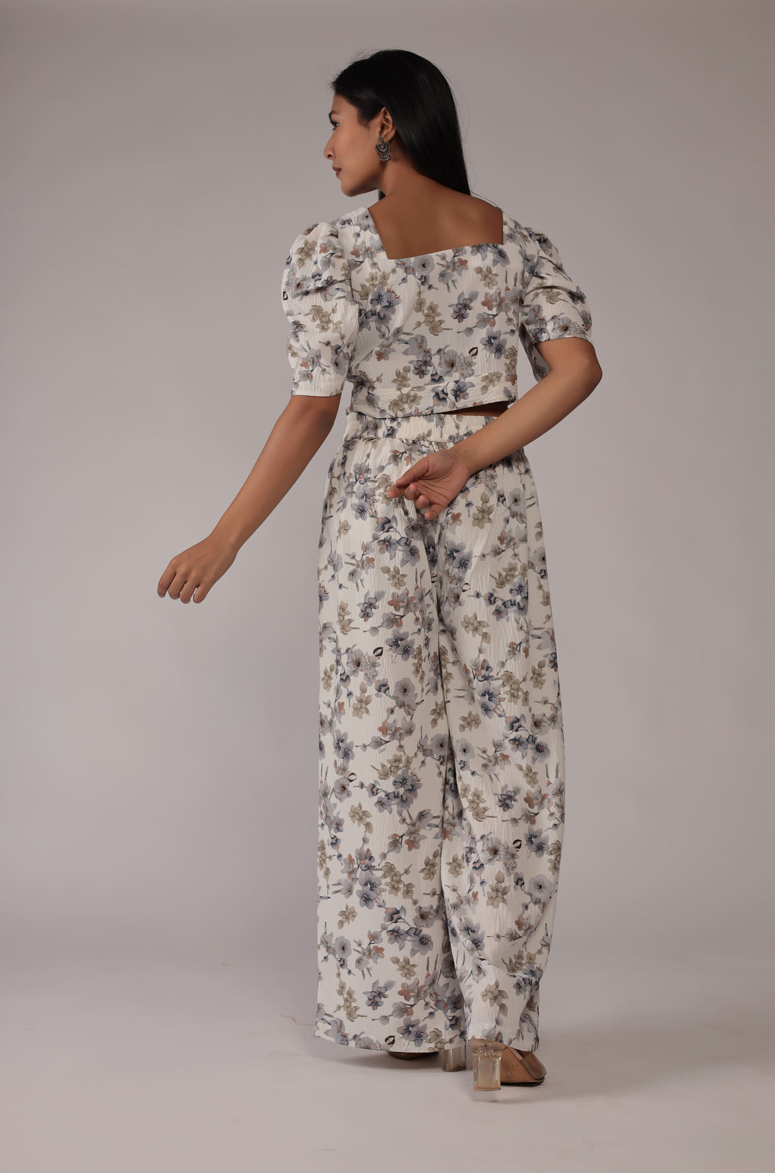 Back view of the elegant cream printed co-ord set, showing the consistent floral pattern on the crop top and wide-leg pants.