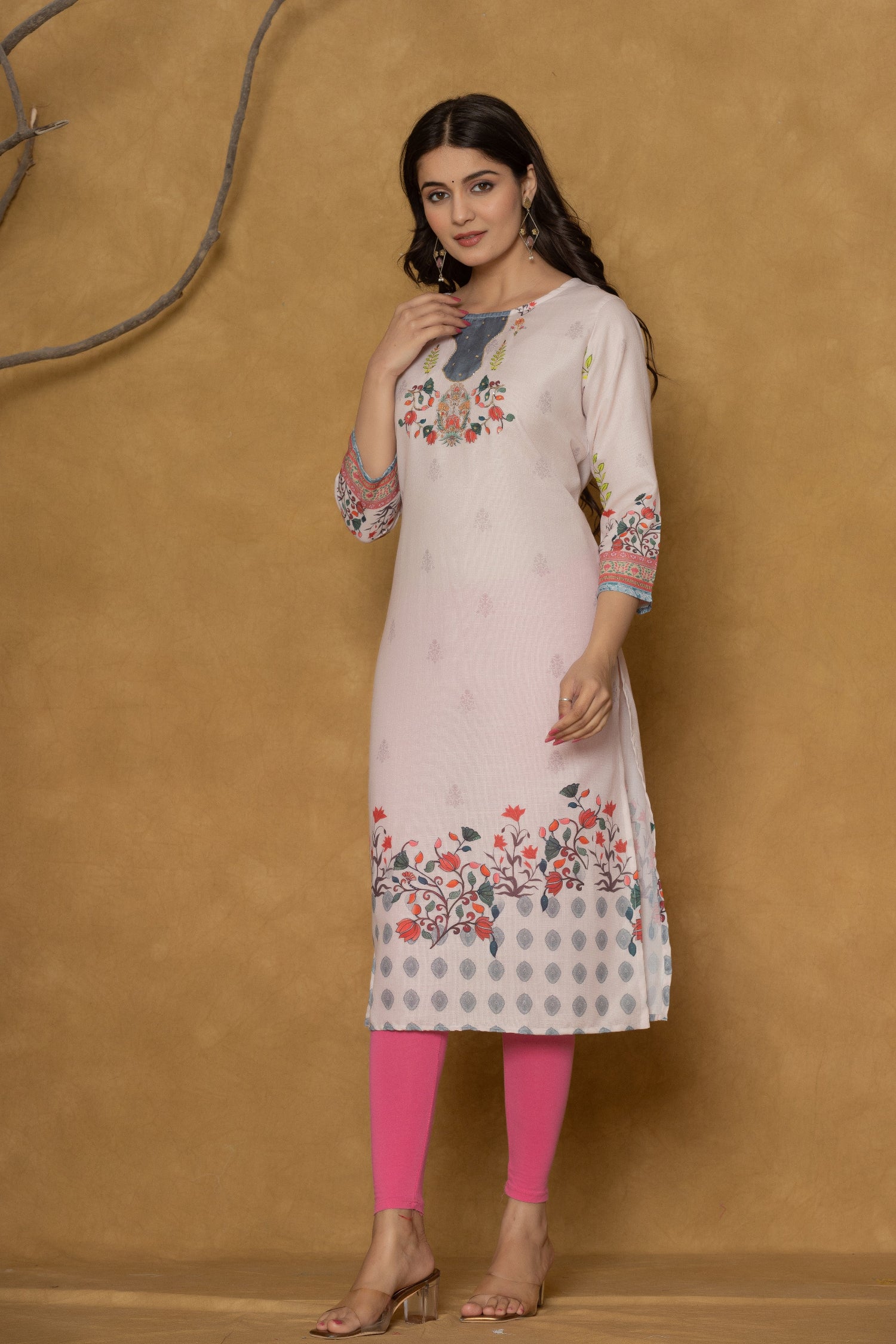 Model wearing a beautiful pink pannel kurta from The Navra, featuring intricate handwork on the neck and delicate floral patterns along the hemline, paired with pink leggings. Ideal for casual and daily wear.