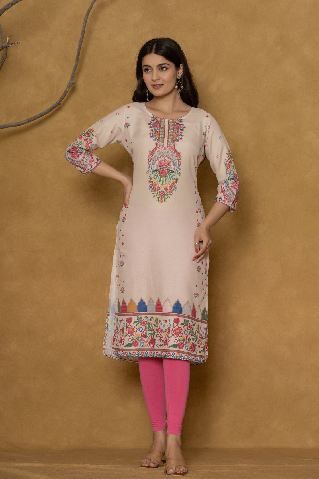 Close-up of the colorful intricate patterns along the hemline of the beige pannel kurta, showcasing the fabric texture and design detail.