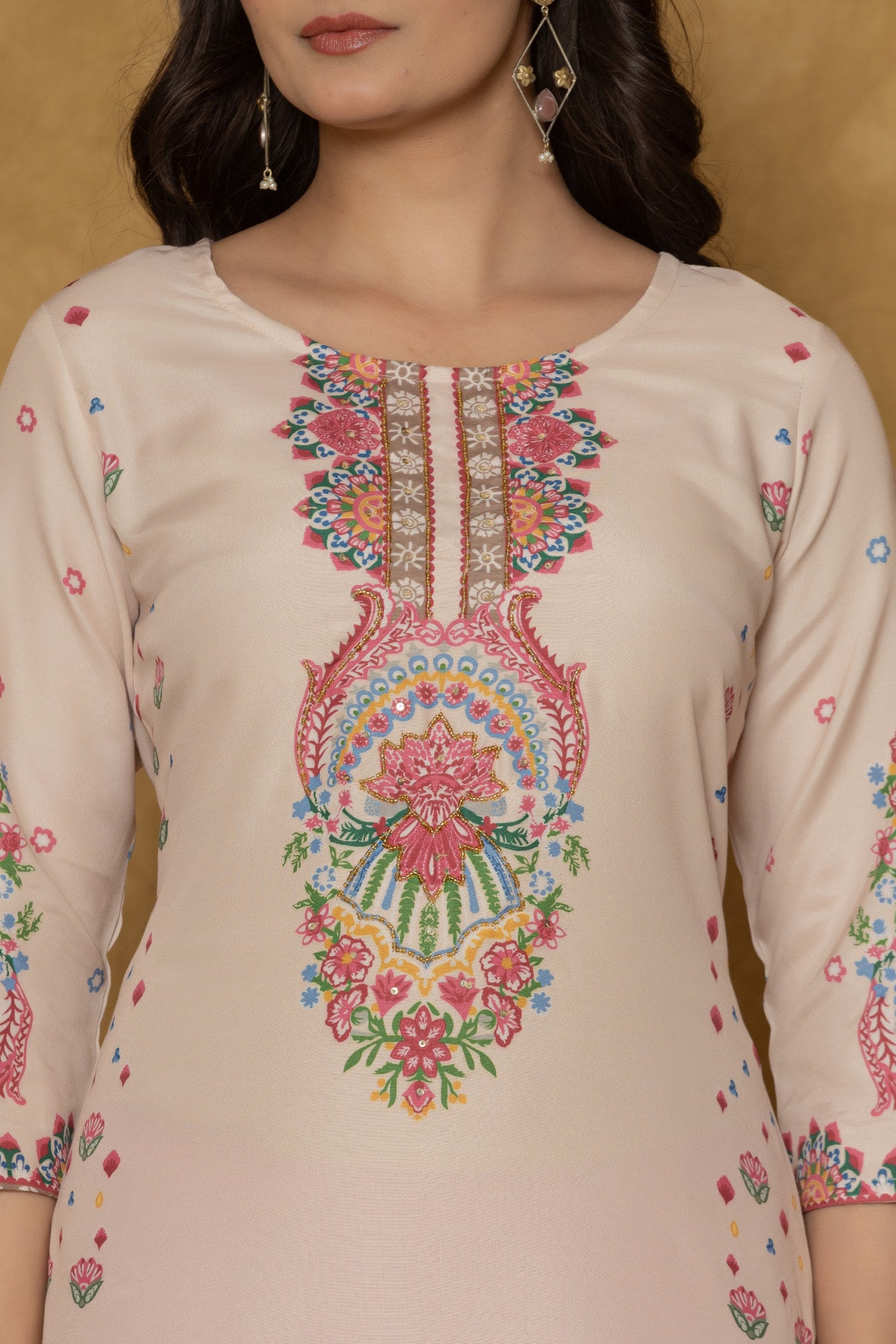 Close-up of the beautiful multi-color handwork embroidery and detailing on the round neckline of the beige pannel kurta, highlighting craftsmanship.