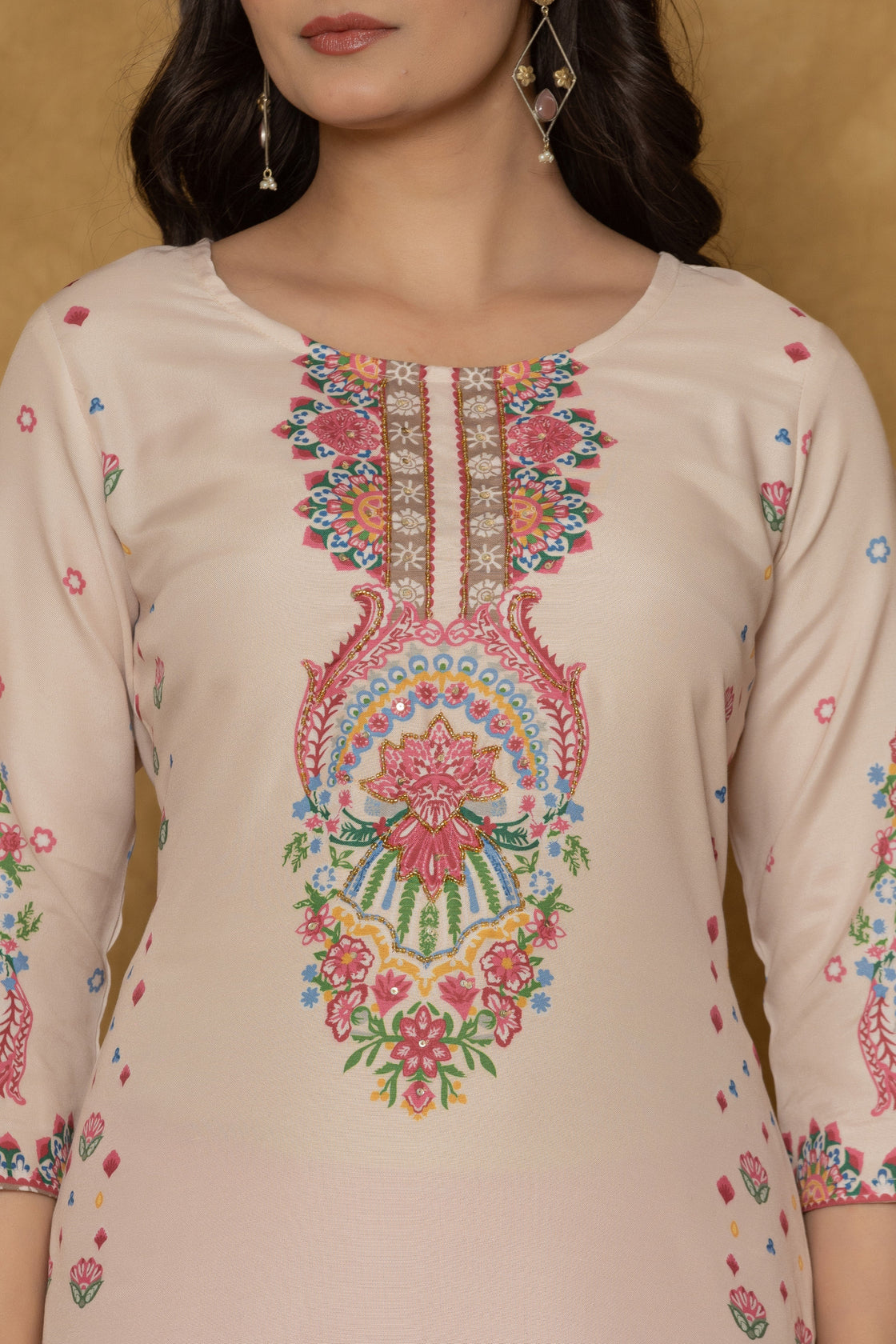 Close-up of the beautiful multi-color handwork embroidery and detailing on the round neckline of the beige pannel kurta, highlighting craftsmanship.