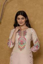 Side profile of model showcasing the comfortable fit and elegant design of the beige pannel kurta with vibrant patterns.