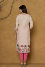 Back view of the beige pannel kurta, showing the clean design and the continuation of the patterns.