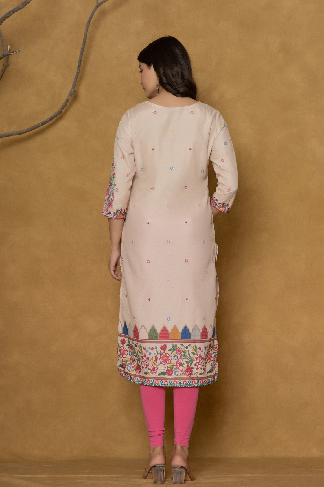 Back view of the beige pannel kurta, showing the clean design and the continuation of the patterns.