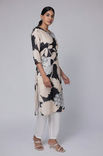Model in a confident stance, highlighting the full length and overall unique abstract print design of the black and beige multicolor cotton dobby kurti.