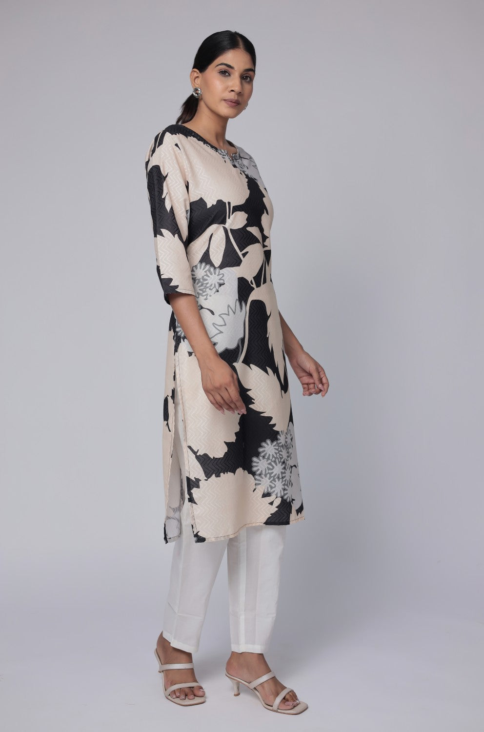 Model in a confident stance, highlighting the full length and overall unique abstract print design of the black and beige multicolor cotton dobby kurti.