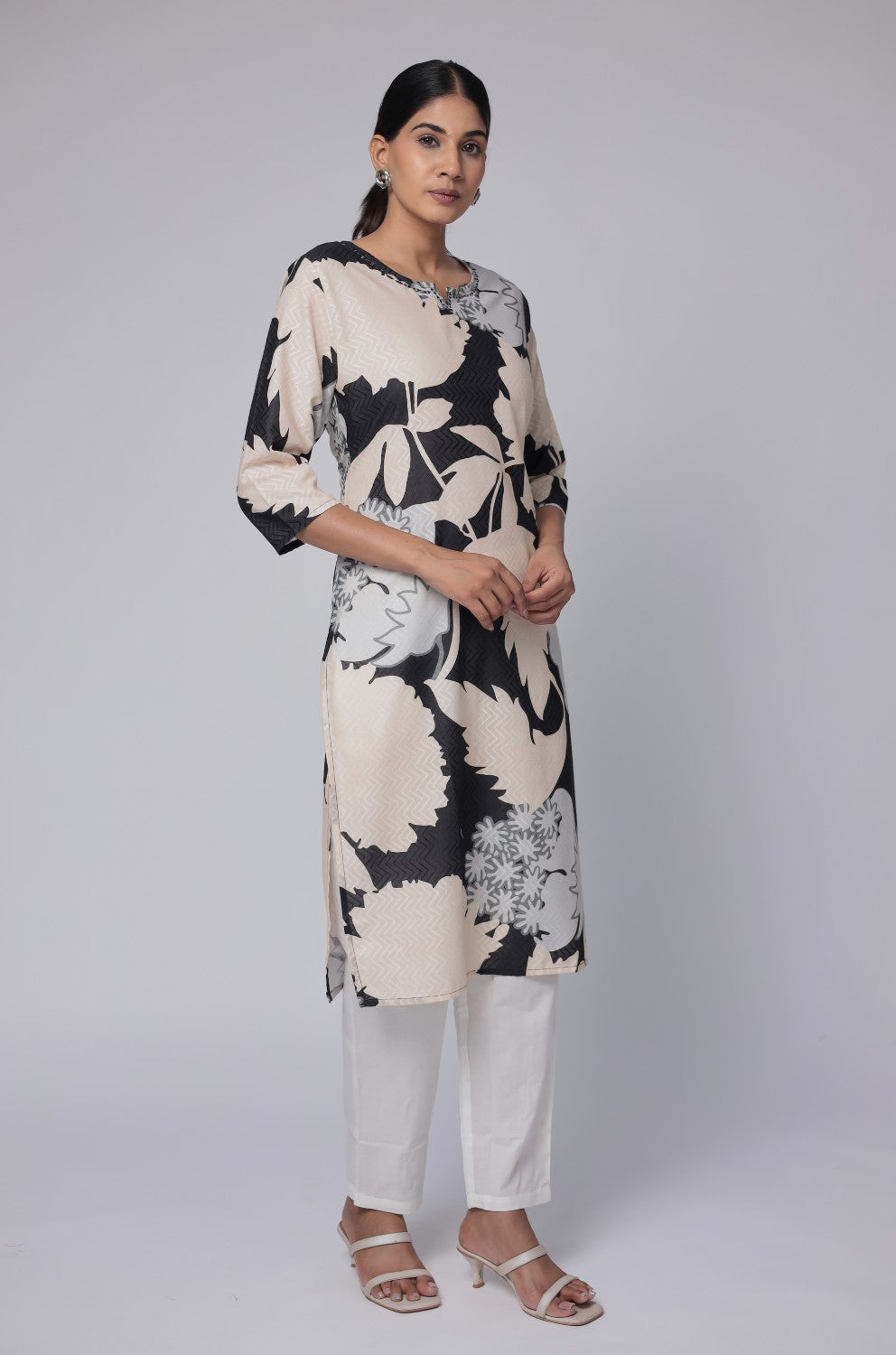 Model gracefully posing in the black and beige cotton dobby kurti, showcasing the comfortable movement and elegant style of the ethnic wear.