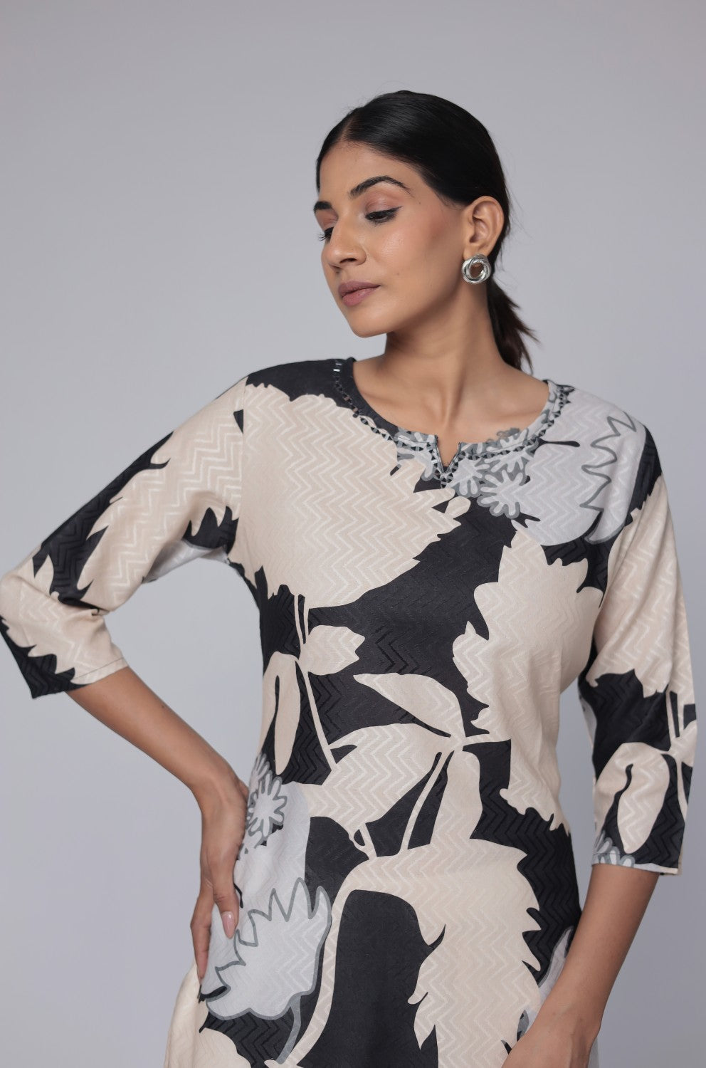 Side profile of model showcasing the comfortable fit and unique abstract design of the black and beige multicolor cotton dobby kurti.