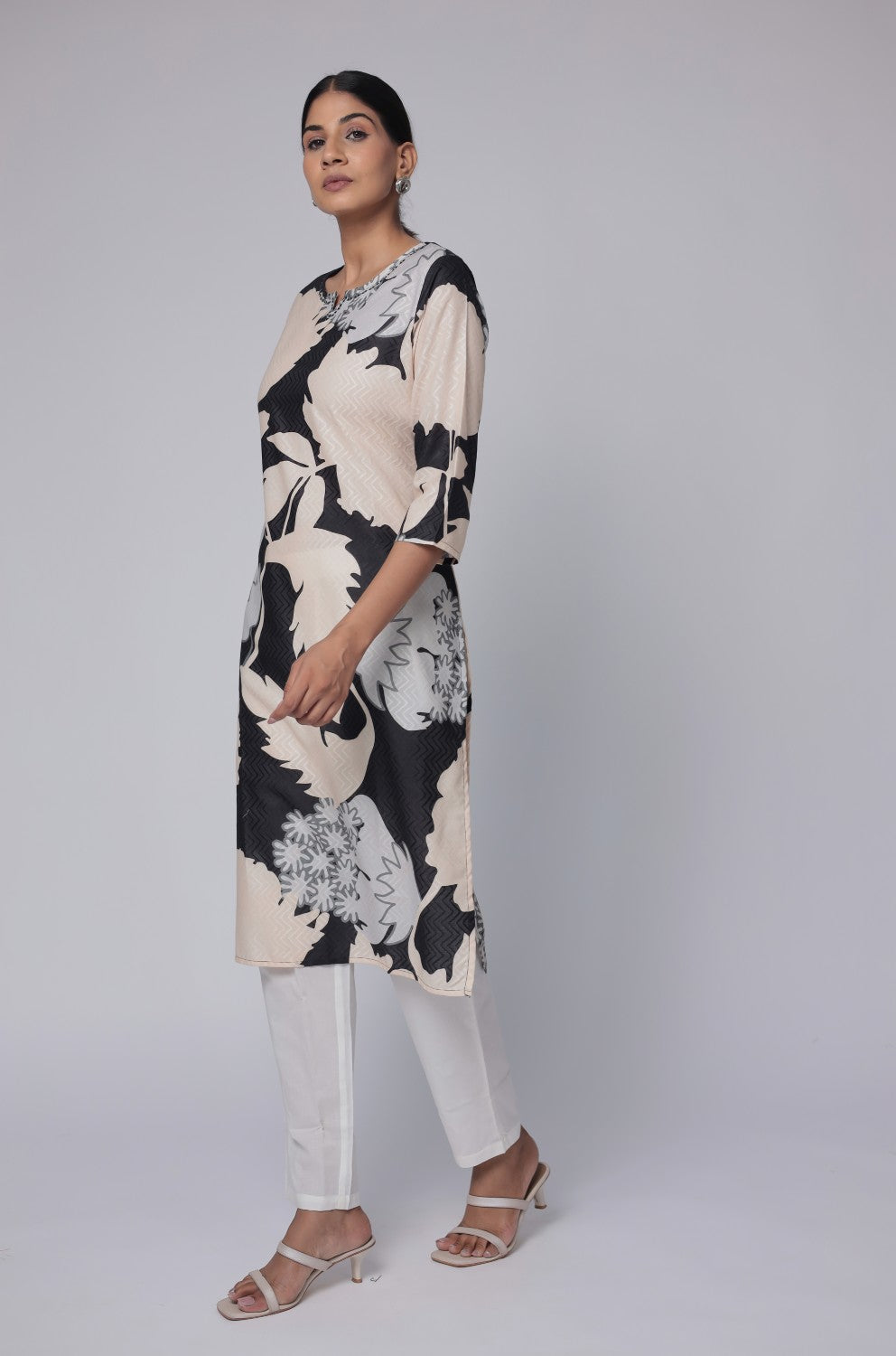 Detailed view of the sleeve and abstract print pattern on the black and beige premium cotton dobby kurti.