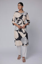 Model wearing a stylish black and beige multicolor premium cotton dobby kurti from The Navra, featuring unique abstract floral prints, paired with white pants. Ideal for comfortable daily or casual ethnic wear.