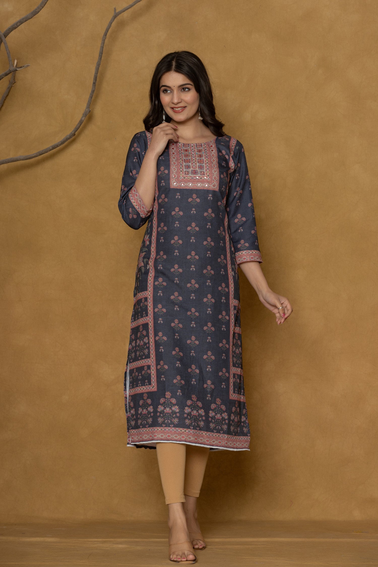 Model in a confident stance, highlighting the full length and overall detailed panel design of the black kurta with handwork.

