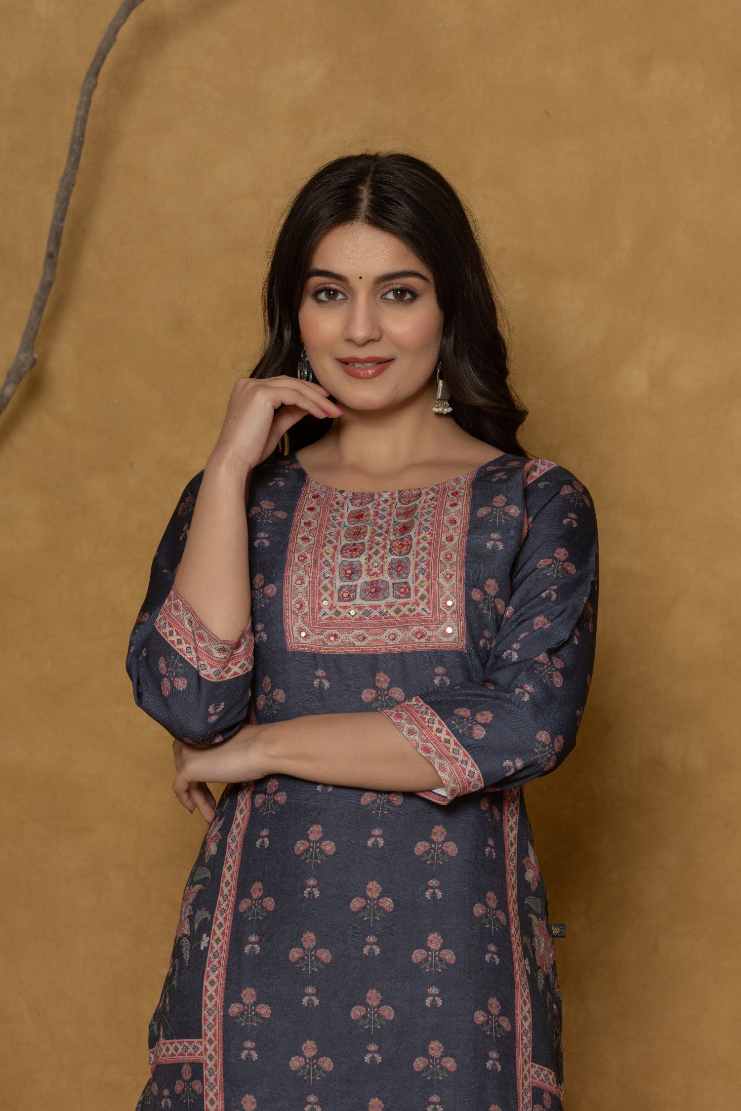 Side profile of model showcasing the comfortable fit and unique panel design of the black kurta with handwork detailing.